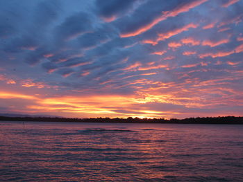 Scenic view of sea against romantic sky at sunset