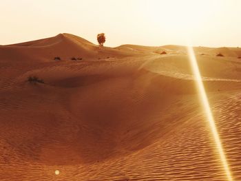 Sand dune in desert against clear sky