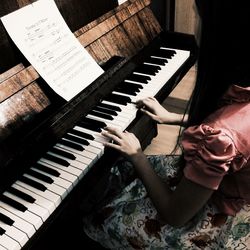 High angle view of woman playing piano