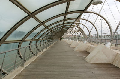 Empty footbridge against sky