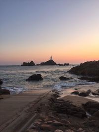 Scenic view of sea against clear sky during sunset