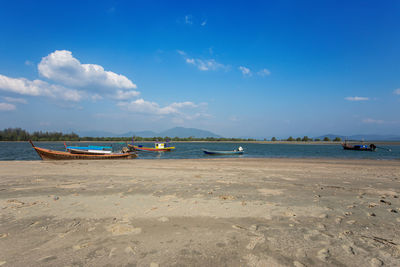 Scenic view of beach against blue sky