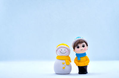 Close-up of figurine toy on table against white background