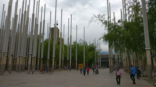 Group of people walking against building in city