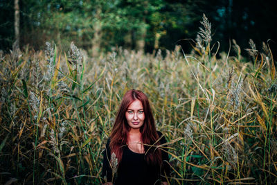 Portrait of woman by plants