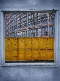 Incomplete building seen from square window