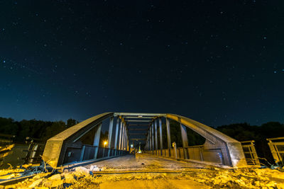 Low angle view of illuminated building against sky at night