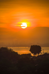 Scenic view of silhouette landscape against romantic sky at sunset