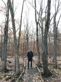 Rear view of man walking in forest