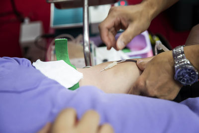 Midsection of doctor examining patient at clinic