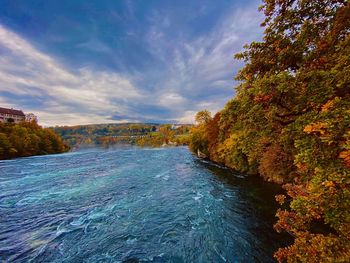 Scenic view of river against sky during autumn