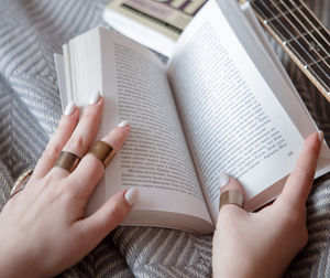 Midsection of woman reading book