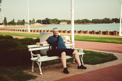 Full length portrait of man sitting on chair