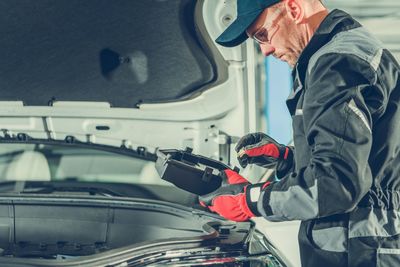 Side view of man working at bus