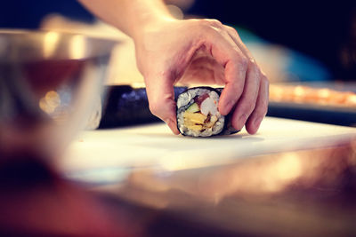 Cropped image of chef preparing sushi in restaurant