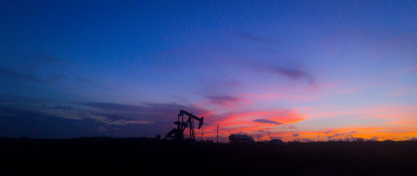 Silhouette landscape against sky at sunset