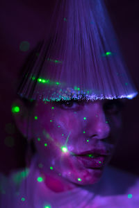 Digital composite image of woman with illuminated lights