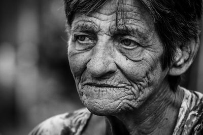 Close-up portrait of senior woman with wrinkled face