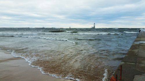 Scenic view of sea against cloudy sky