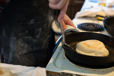 Close-up of person preparing food in kitchen