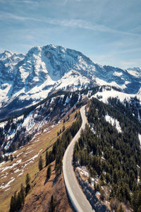 High angle view of snowcapped mountains against sky