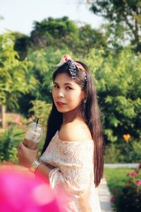 Portrait of a serious young woman drinking glass