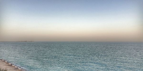Scenic view of sea against clear sky during sunset
