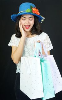 Portrait of a smiling young woman wearing hat