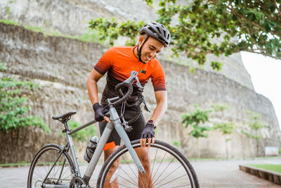 Young man riding bicycle