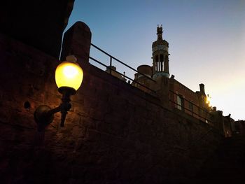 Low angle view of illuminated lamp at night