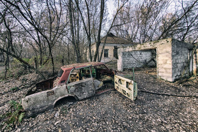 View of abandoned car on bare tree