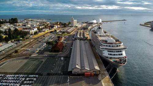 High angle view of city by sea against sky