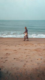 Boy on beach by sea