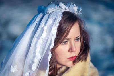 Close-up portrait of young woman wearing scarf