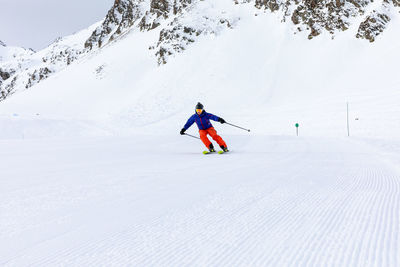 Man skiing on snow covered land