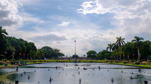 Scenic view of lake against cloudy sky