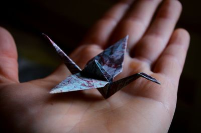 Cropped image of person holding origami