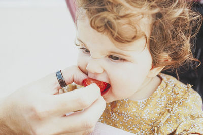 Close-up portrait of girl eating food