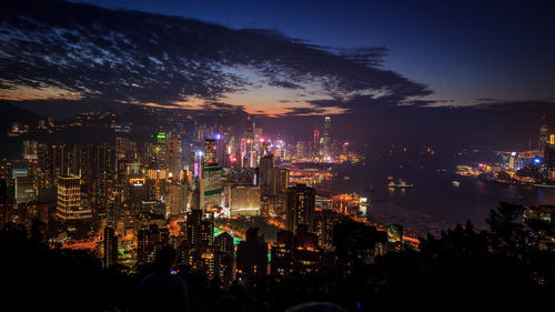 High angle view of illuminated city buildings at night