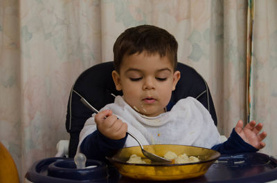 Boy holding ice cream in bowl