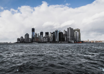 Sea and cityscape against sky