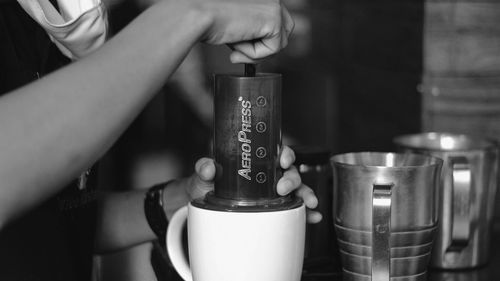 Close-up of hand holding coffee cup