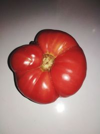 High angle view of red bell pepper against white background