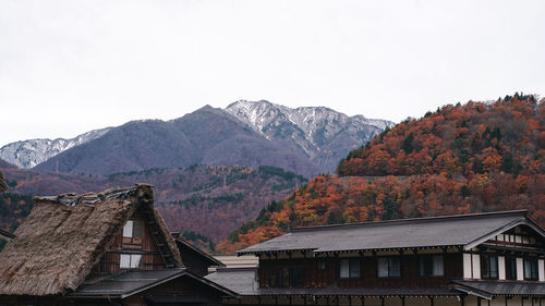 Houses against mountains against clear sky