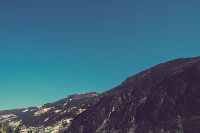 Low angle view of mountain against clear blue sky