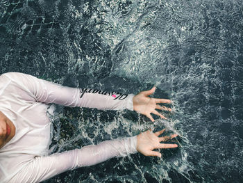 Low section of woman swimming in sea