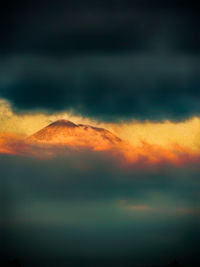 Low angle view of storm clouds in sky during sunset