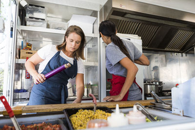 Multi-ethnic female colleagues working in food truck