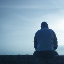 Rear view of man standing against sky