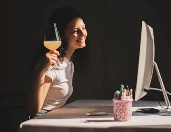 Girl talking on video call and toasting, celebrating